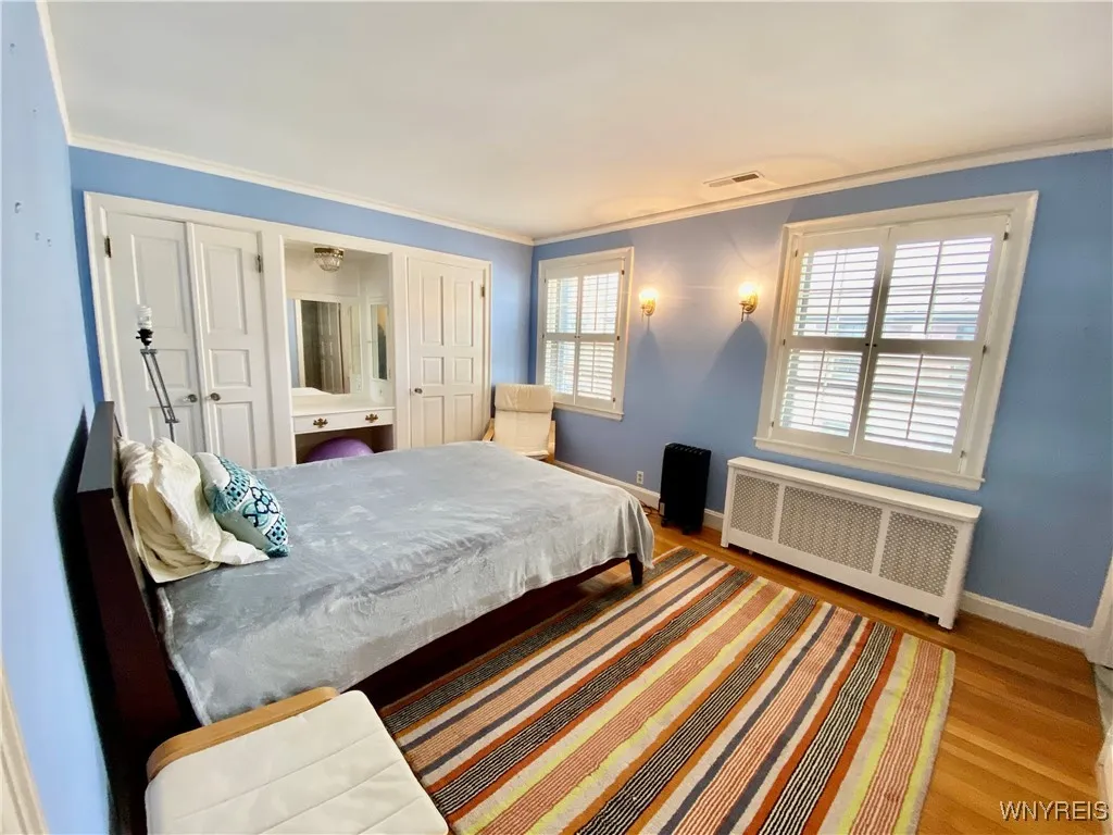 Primary ensuite with dual closets, and a vanity.