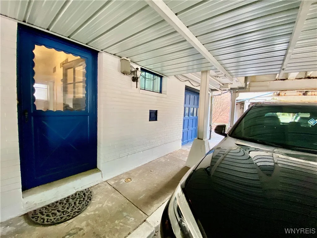 Lower level entrance with 1 covered parking space.