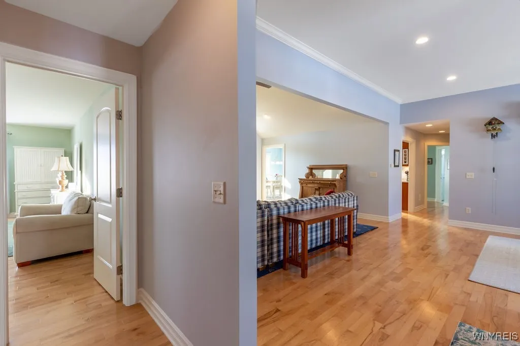 Hallway on opposite side of primary bedroom features a second ensuite, 3rd bedroom and full bath.