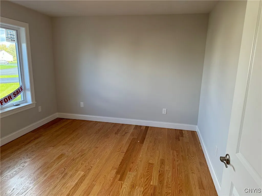 Front Bedroom or Den offers large window with Hardwood floors