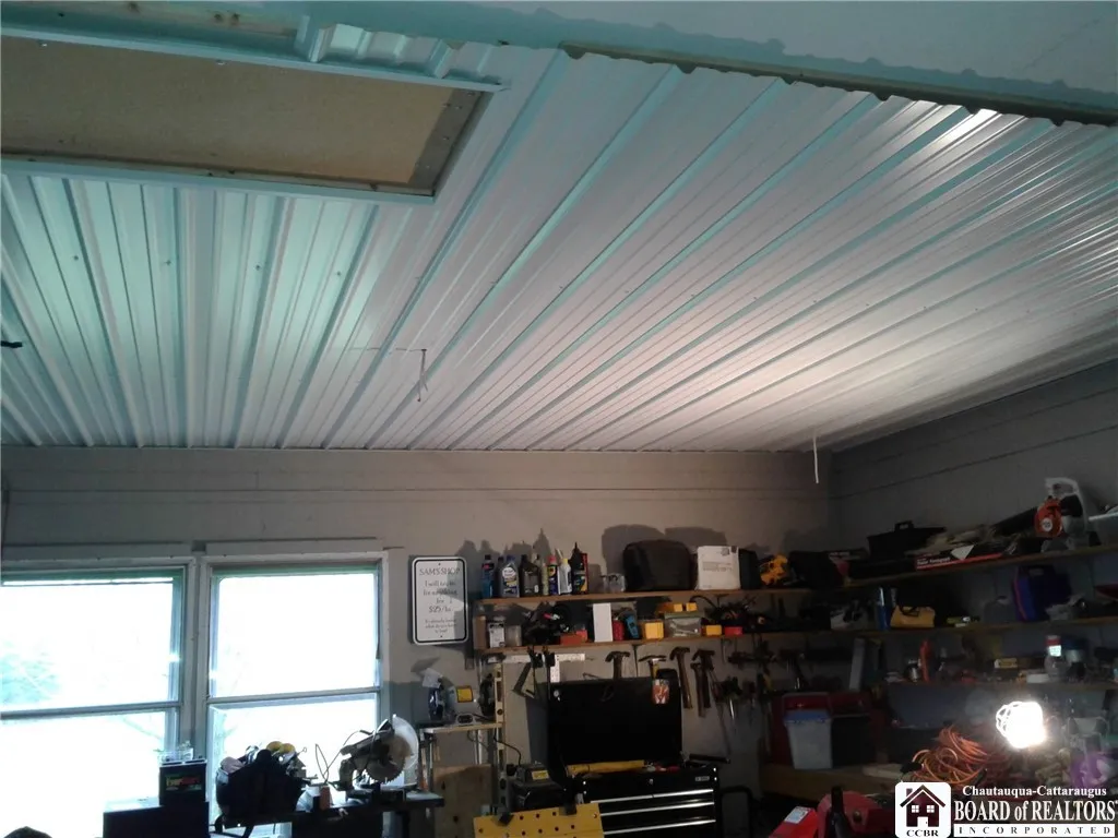 Garage has pull down stairs to floored attic for additional storage