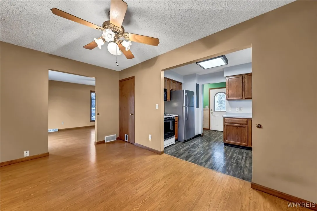 Dining room with view into kitchen and living room.