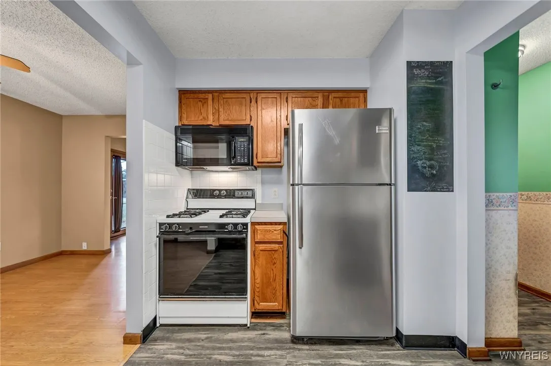 View to the dining room on the left and entry way with walkthrough to living room on the right.