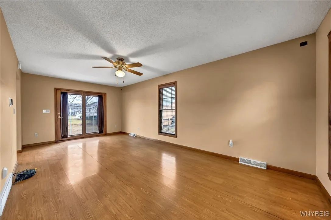 Living room with beautiful French doors leading to concrete patio.  Living room is hard wired for speakers.