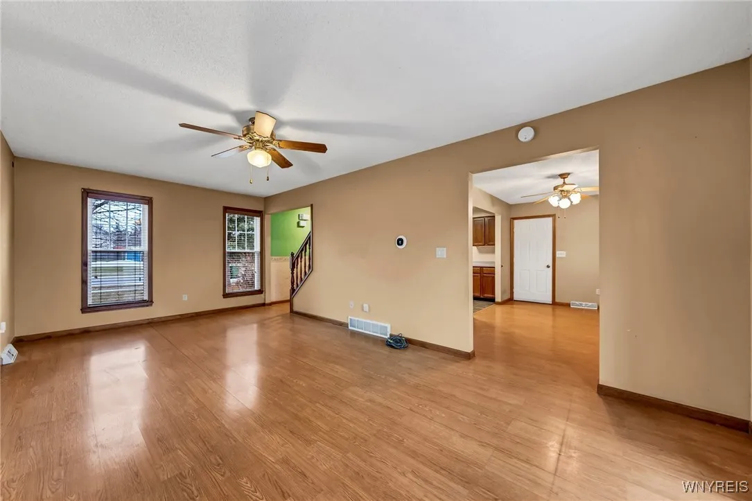 View of living room towards front entry and stairs leading to bedrooms.