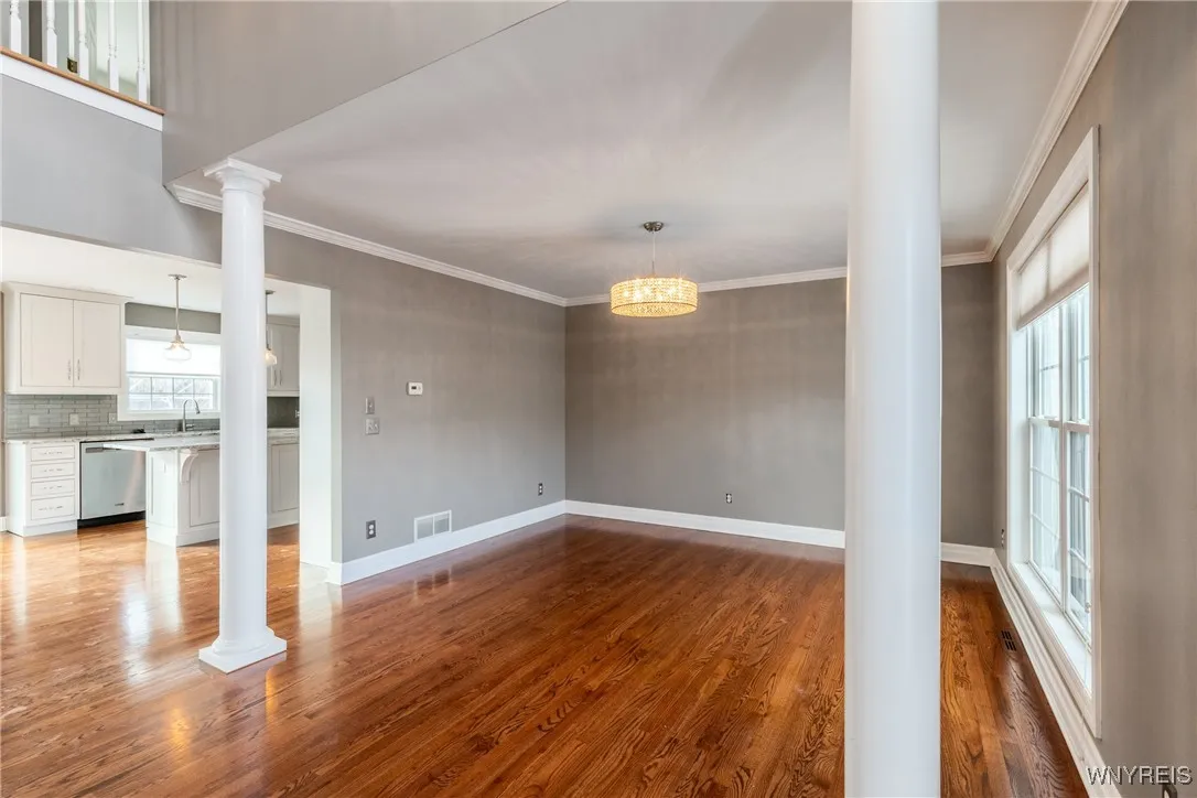 Formal dining room with beautiful pillar to accent the room.  Notice the clean hardwood flooring.