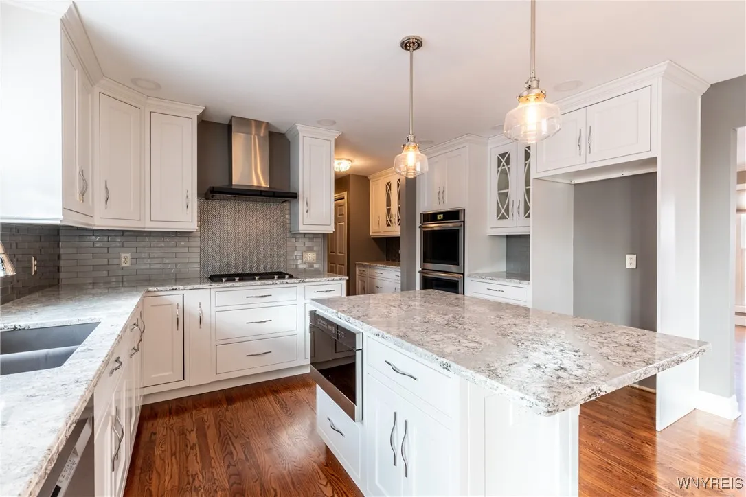 Newer stainless steel built-in appliances.  Double oven, microwave, dishwasher, gas cooktop and custom stove cooktop vent.