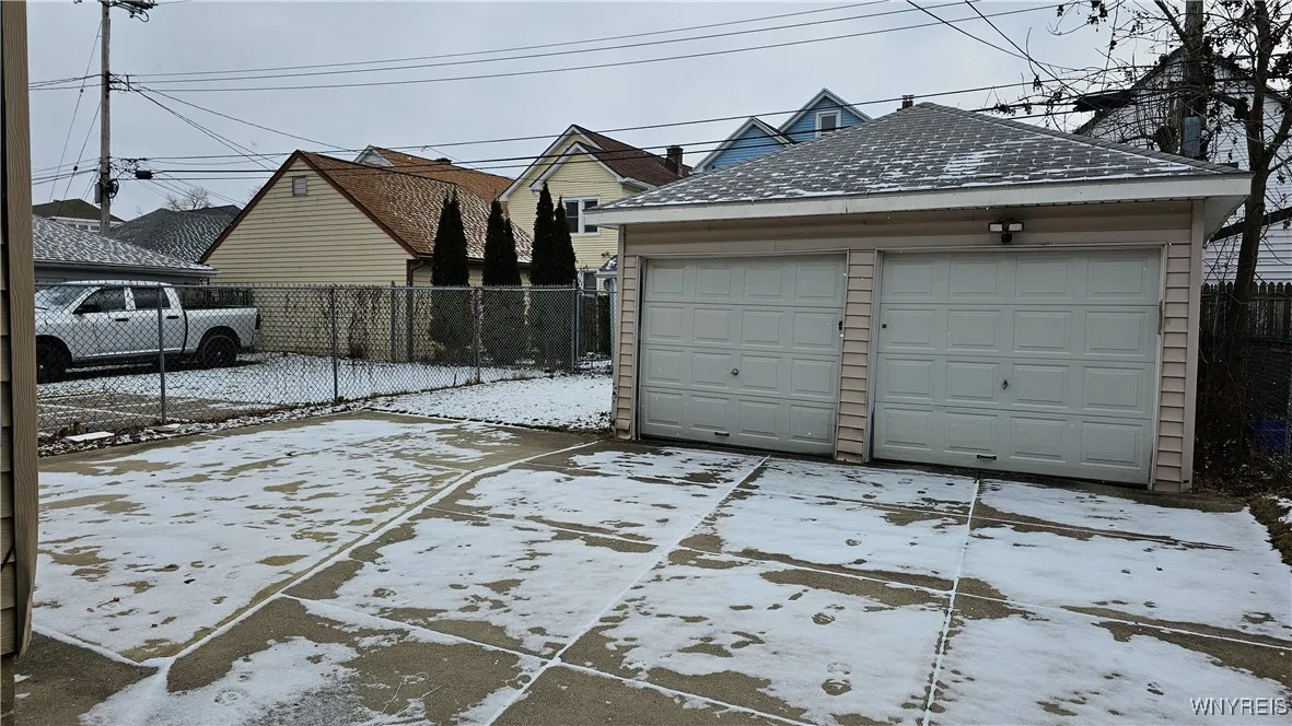 Concrete patio, parking pad and 2-car garage
