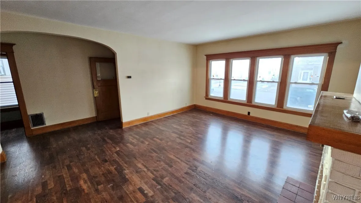 Oversized living room looking to closet and front entry