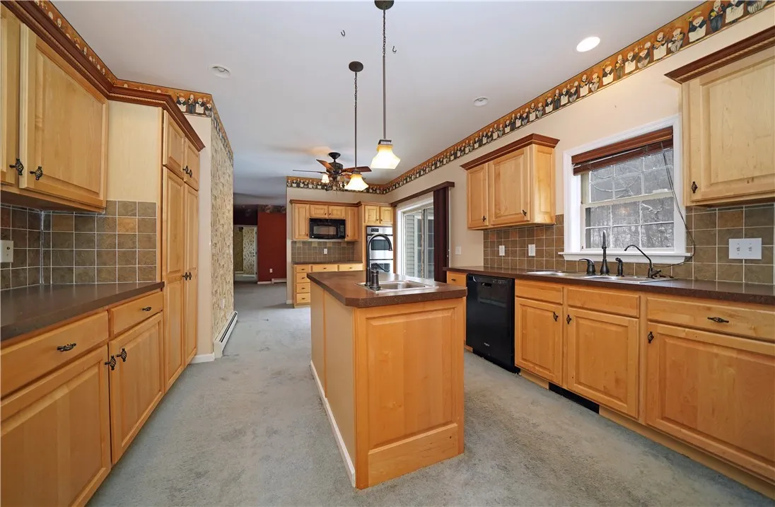 Kitchen with double oven and sliding doors to deck