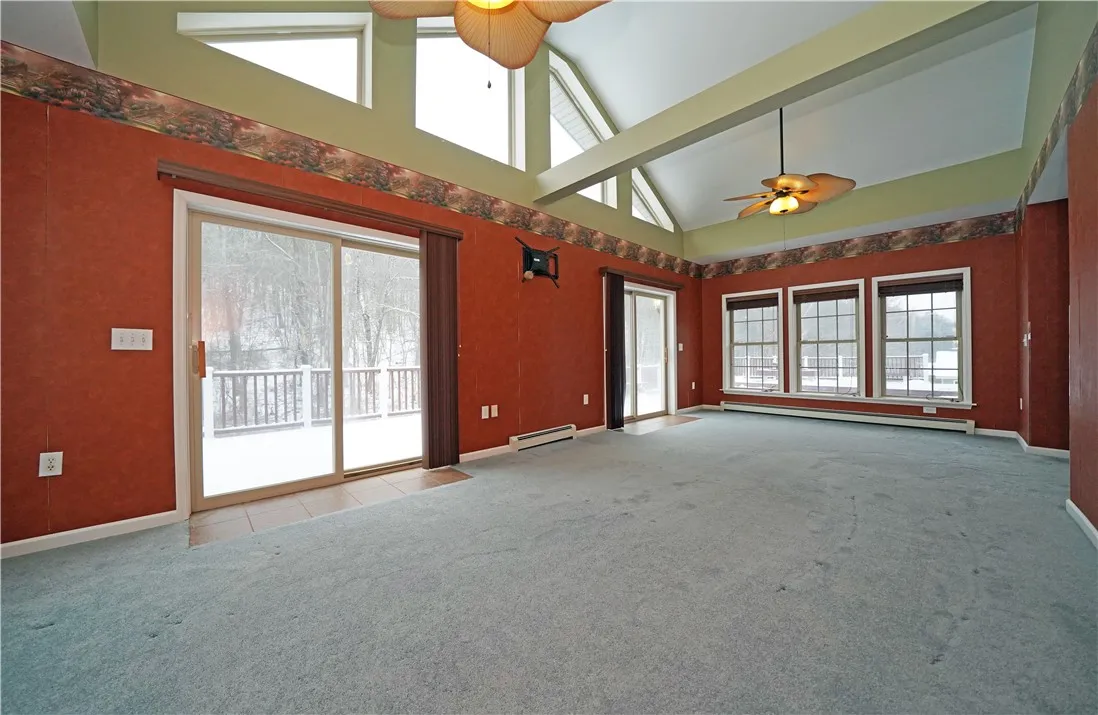 Sliding doors off the Great Room with vaulted ceilings to wrap around deck
