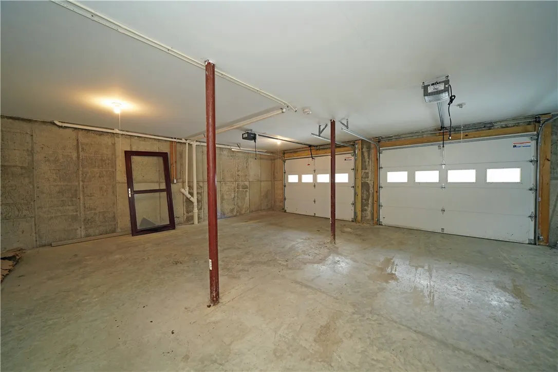 2 car garage with man door to the North