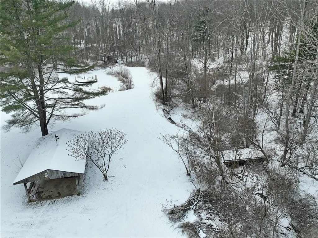Pavilion next to the walking bridge over the creek to back side of property