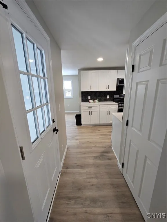 Hall from living room to kitchen.  Door on right is mudroom, door on left leads to basement