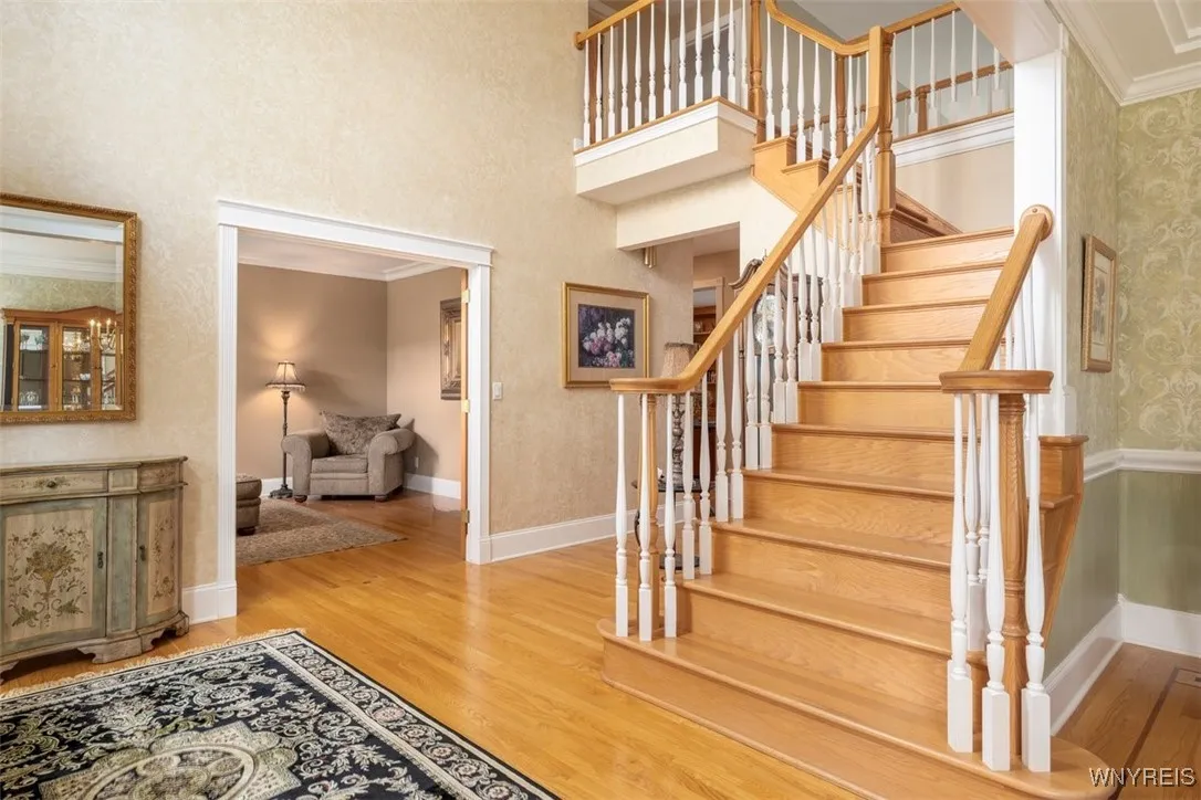 Enter into the 2-story foyer with hardwoods throughout most of first floor, stairs and second floor hallway.