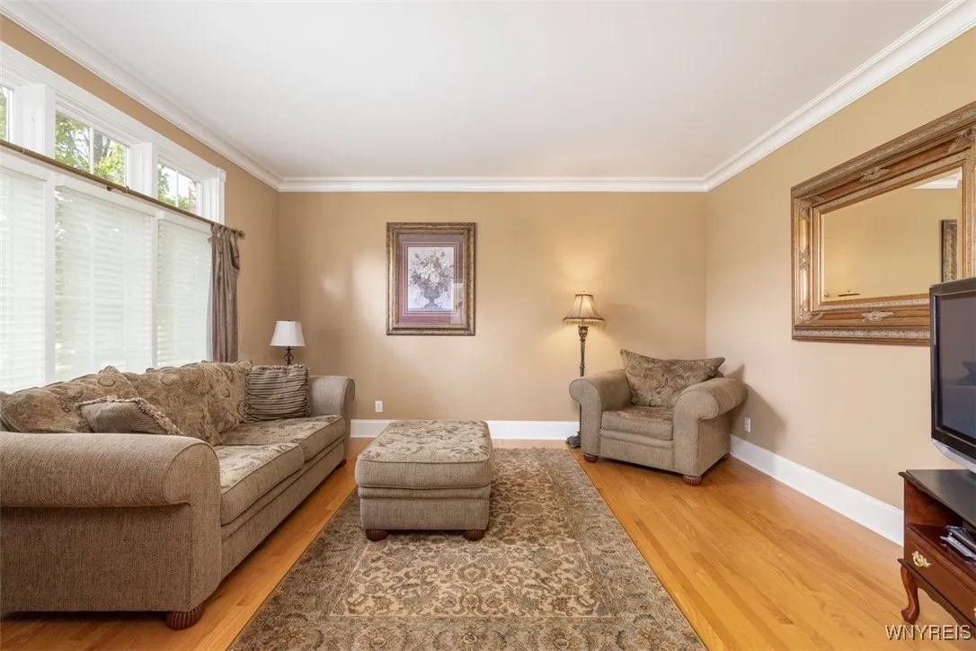 To the left off foyer is a great flex space with French doors for privacy.  Note the beautiful trim work around the transoms, large baseboard and crown molding. Living room, library, workout area, you decide!