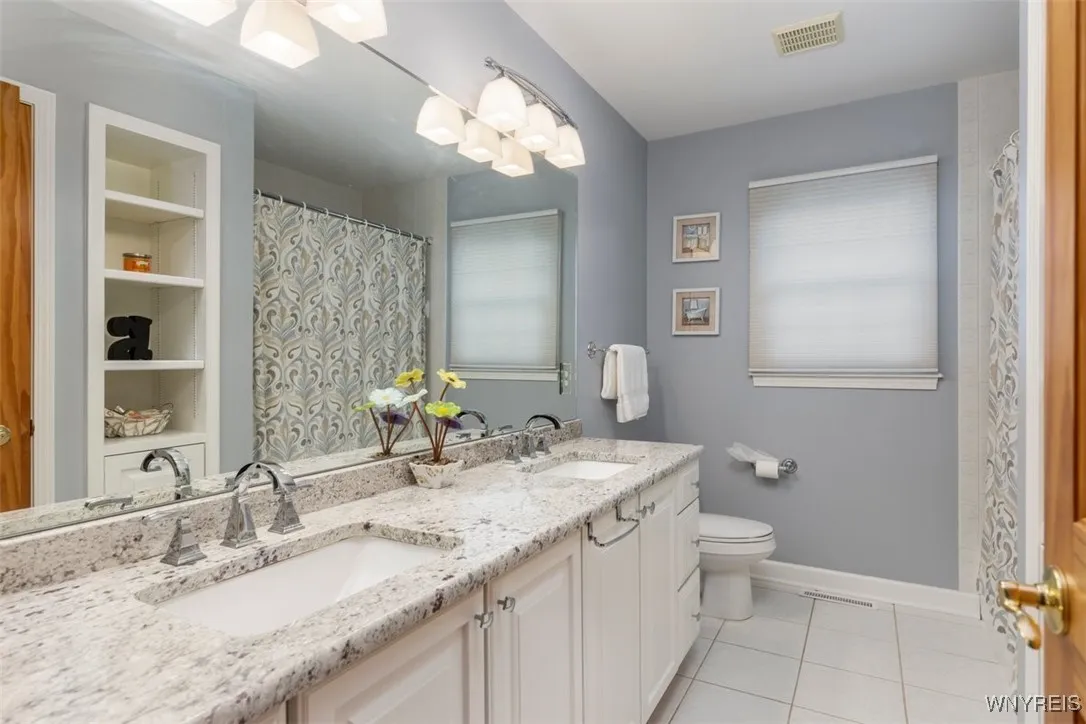 Updated main bathroom with double sinks, granite, tub/shower combo.