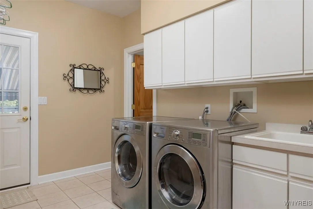 Laundry room with rear access to the pool.  Half bath attached so you don't drip onto the hardwoods!  Washer and dryer convey.