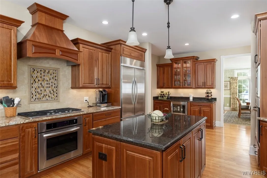 Bar area with lighted cabinets and wine chiller, lots of room to entertain in this kitchen!