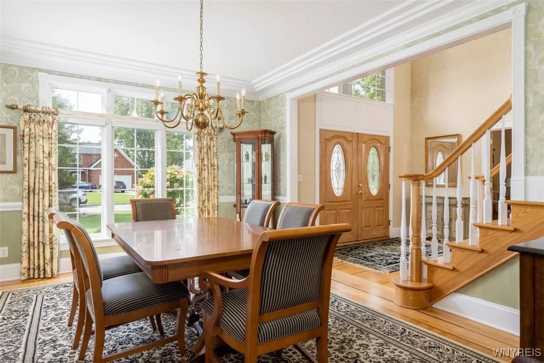 To right off foyer is formal dining room with hardwoods with inlay, wainscoting, crown molding.