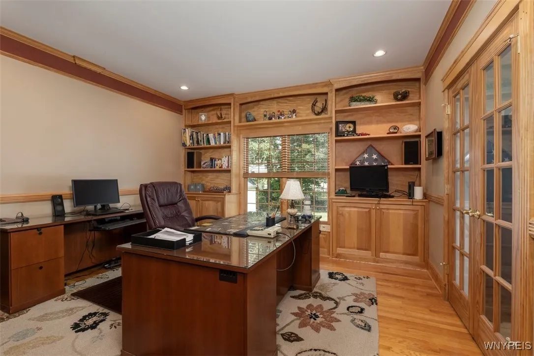 Private office with French door entrance from hall or family room.  Custom trim work and hardwoods.