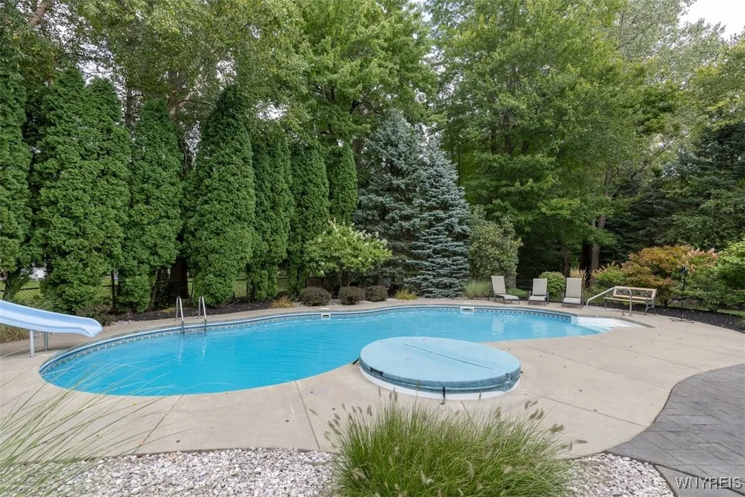 Yard extends behind the tree line at the right as well.