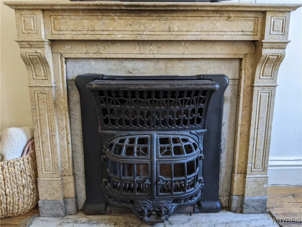 Living room features a stunning, decorative cast iron & marble fireplace