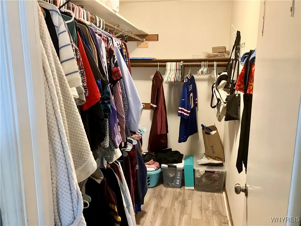 Walk in closet in primary bedroom
