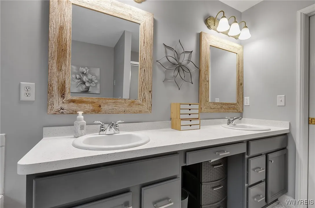 Large vanity holding double sinks and twin mirrors