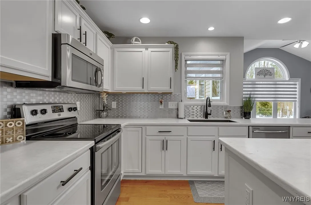 Electric stove and hard surfaced countertops. Great lighting and window to lookout into private yard