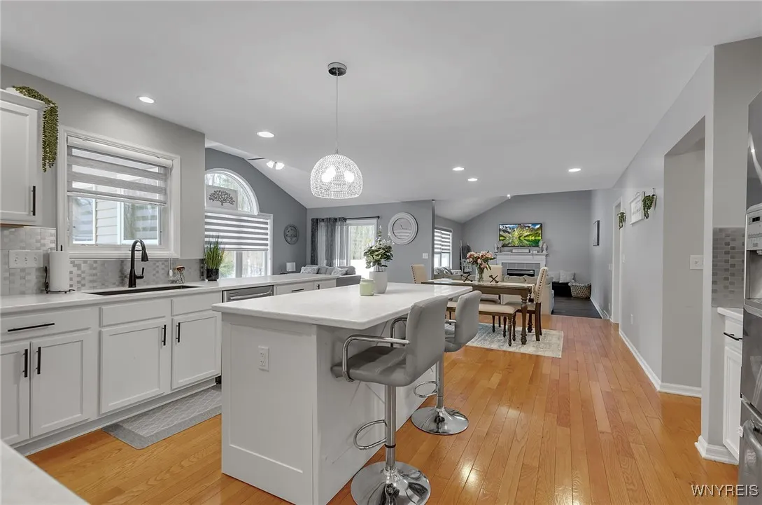 Very bright remodeled kitchen in neutral grey and white with stainless steel appiances
