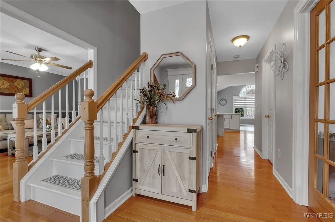 Front foyer boasting the beautiful flow this home offers. Dining to left, den to the right, enter hallway to access closet, basement stairway and half bath.