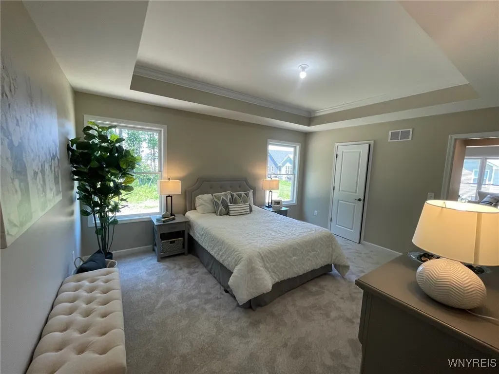 Primary bedroom with a tray ceiling