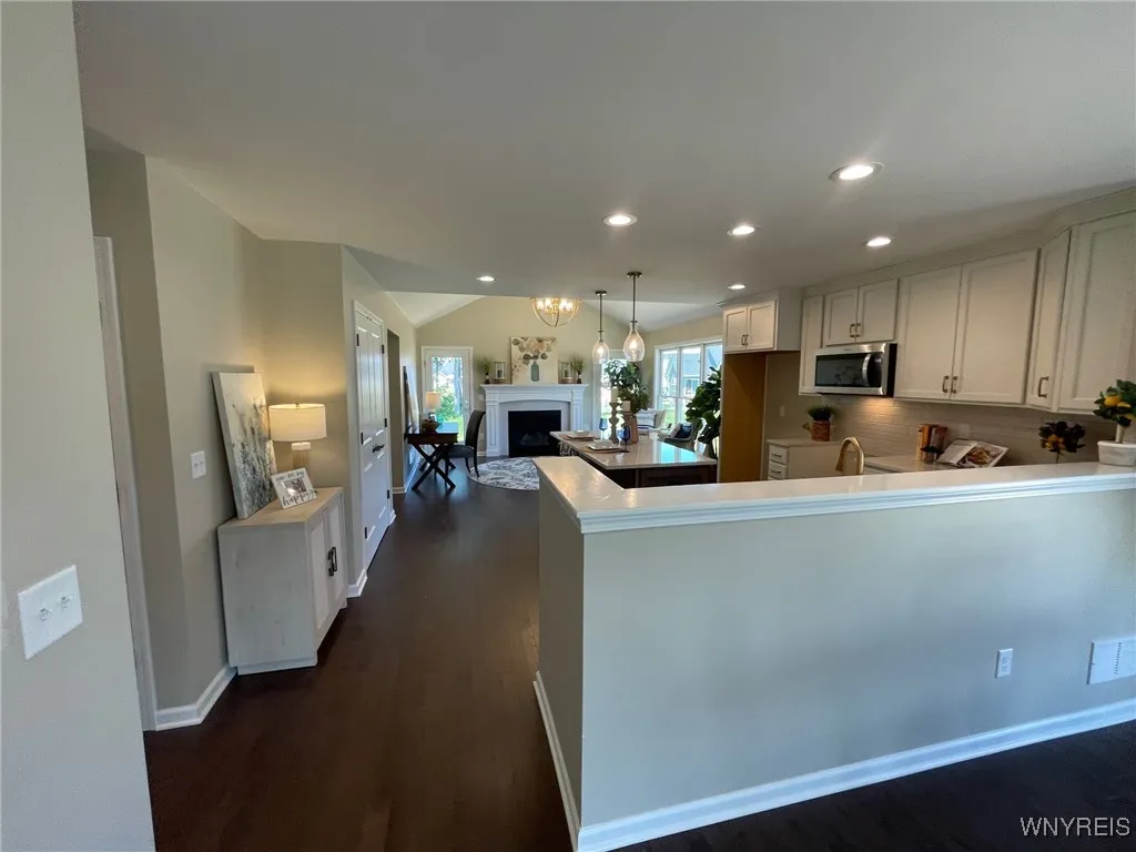 Kitchen overlooks sunroom and dining area