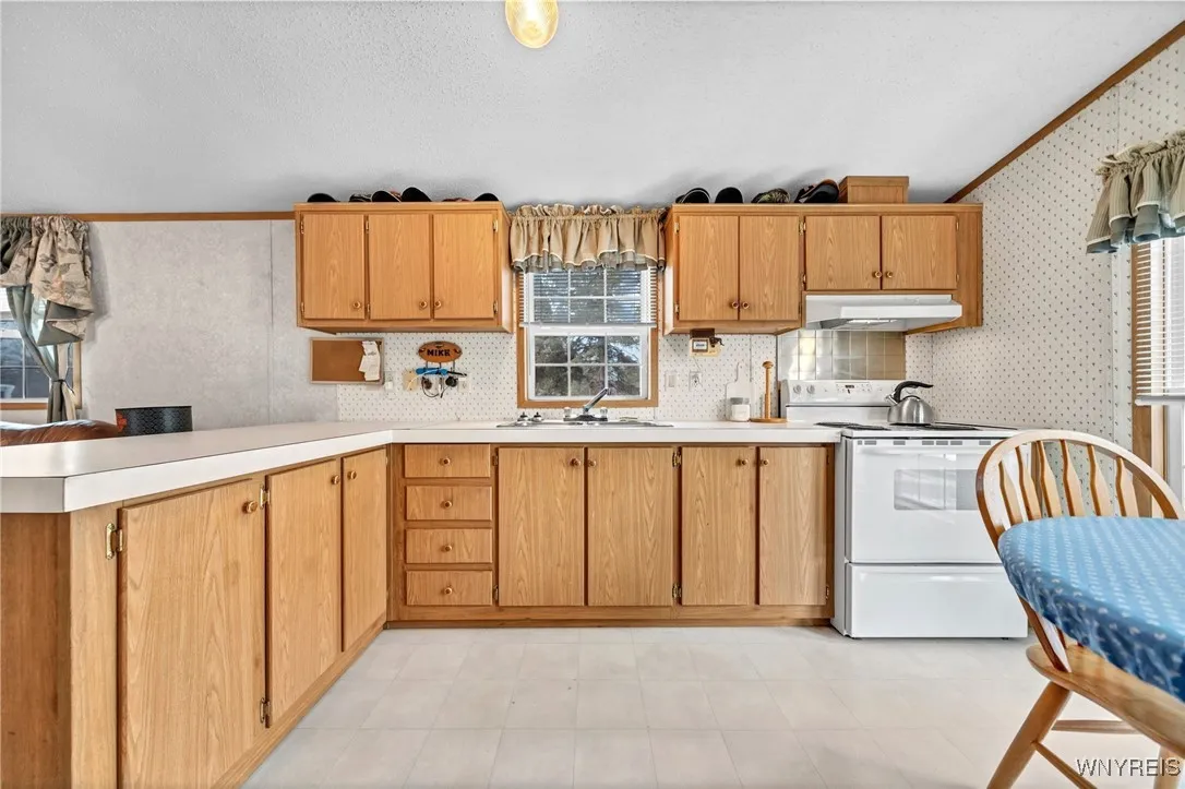 Plenty of cabinet space and an island end for extra counter space.
