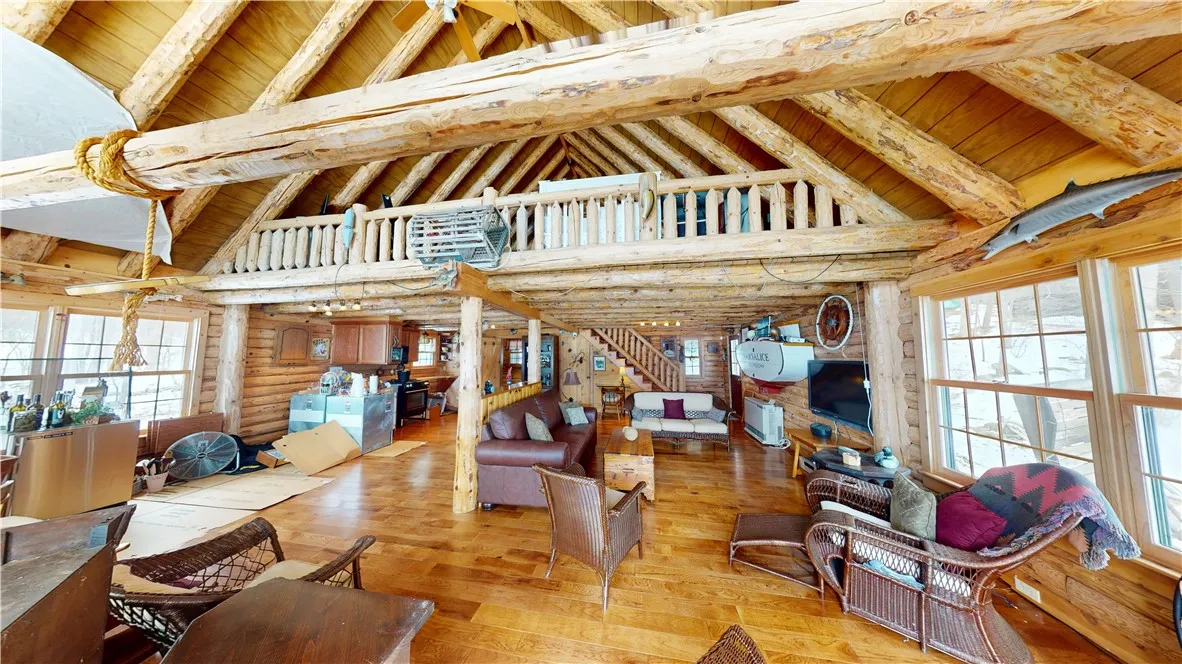 From the deck looking into the boathouse.  Loft above has tons of space for bed(s). Rinnai heater on first floor. Mini split for heat and AC on loft level.