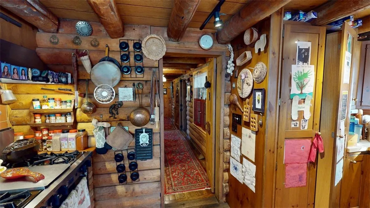 Kitchen peering into the hallway which leads to the primary bedroom (no photos of that at this time), entry, half bath and laundry room.
