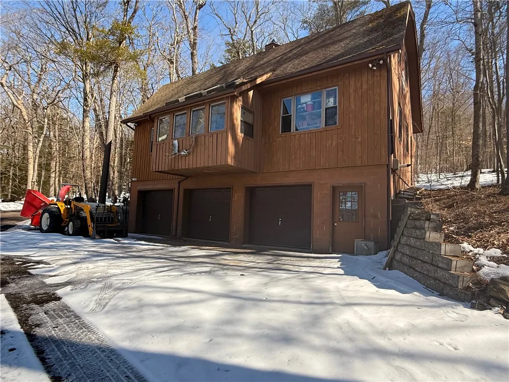 Rear side of 3-story barn. 3 bays & workshop inside. All heated. Electric, water. Second and third floors can easily be finished into extra living space.