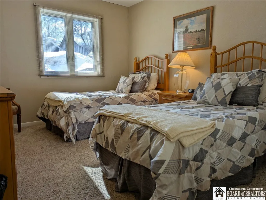 Second bedroom with two twin beds across from the guest bath