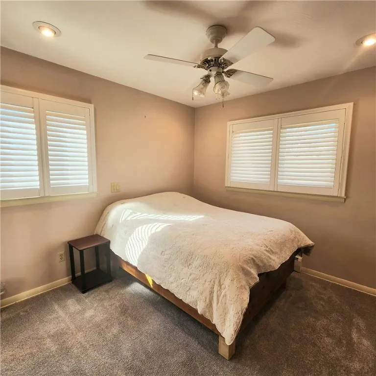 Second bedroom has new windows, shutters, carpet, and lighting