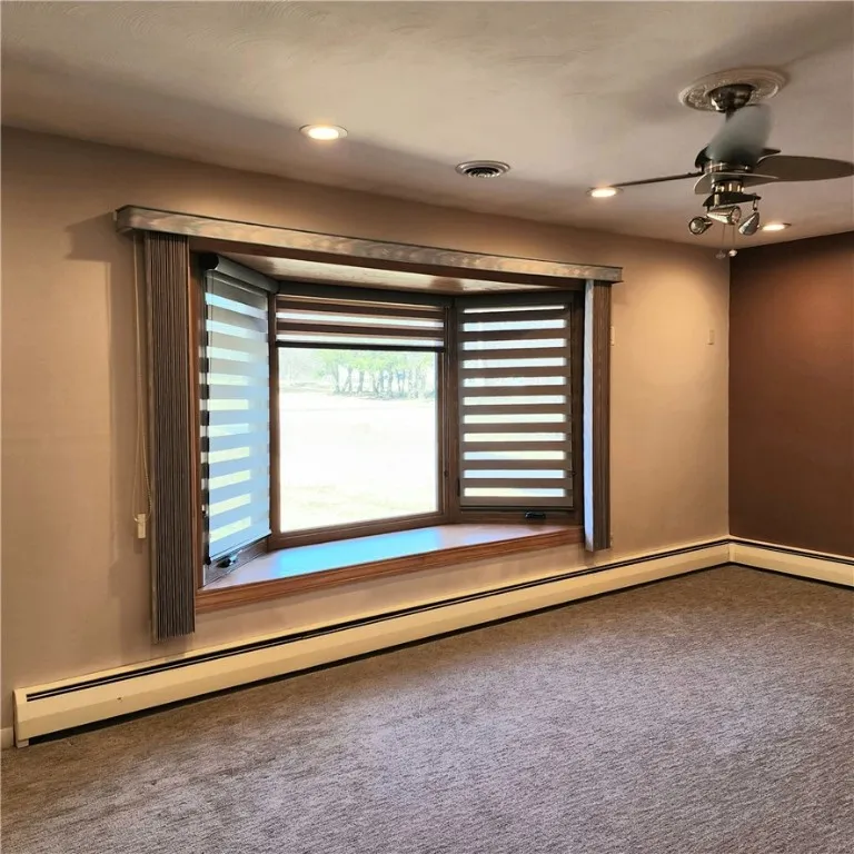 Bay window with custom shades and vertical blinds as well