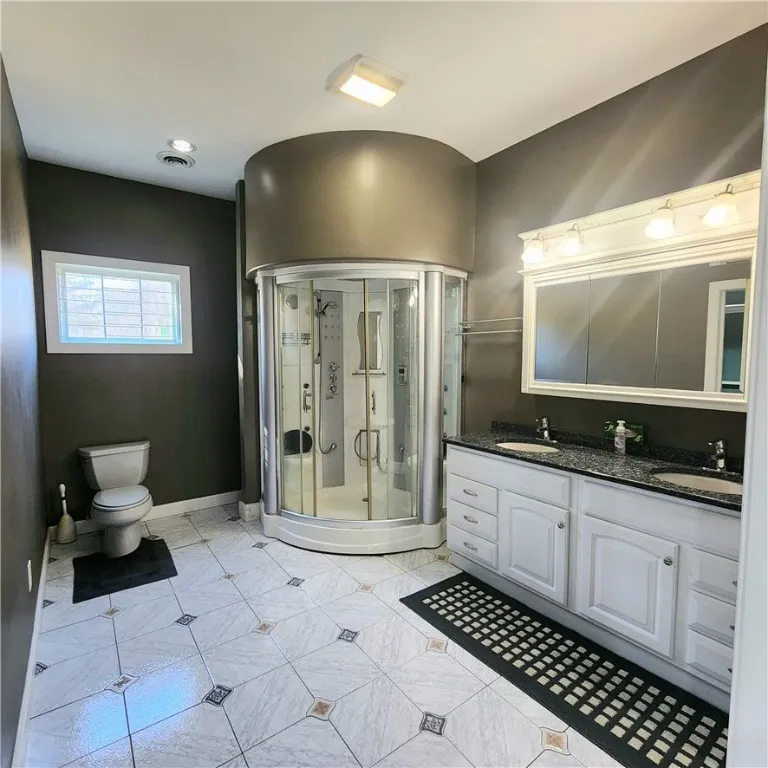 Spa shower and dual sinks for luxury and convenience