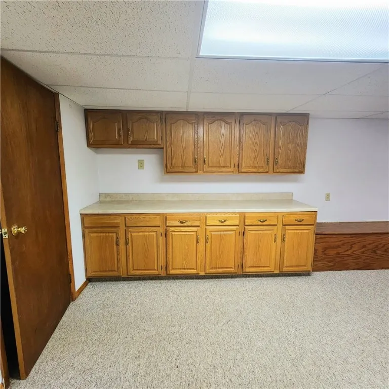 With this counter area, sink, and refrigerator you could have a second kitchen space in the basement.