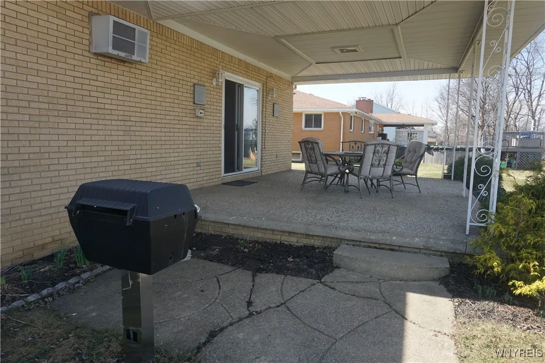 Beautiful covered rear patio for relaxing & entertaining!  Built in gas grill.