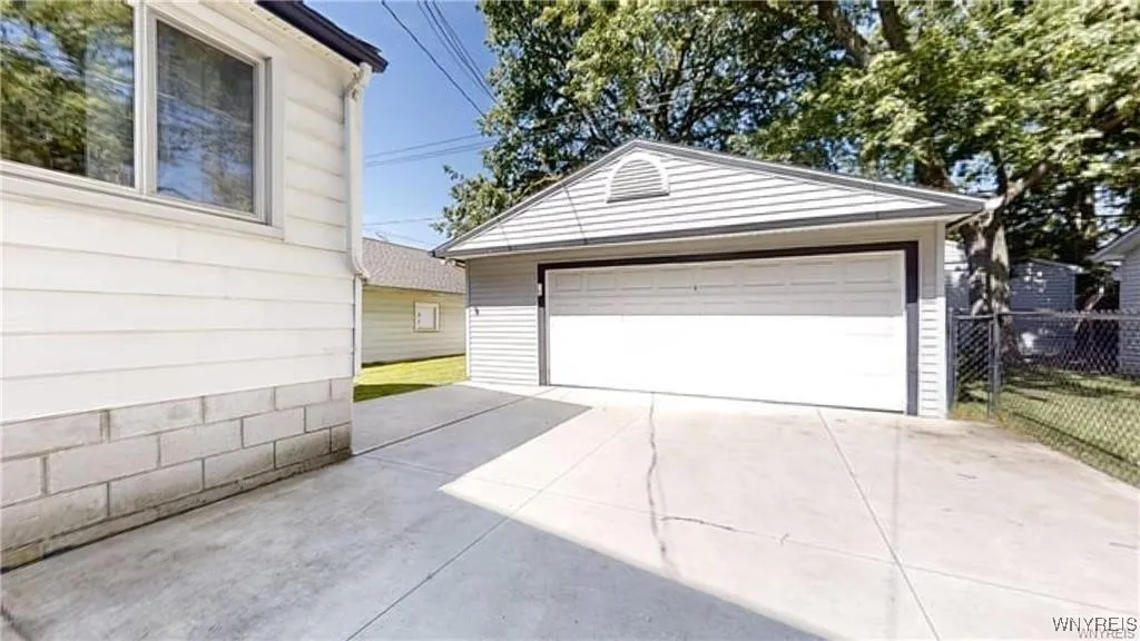 newer garage and extra wide concrete driveway