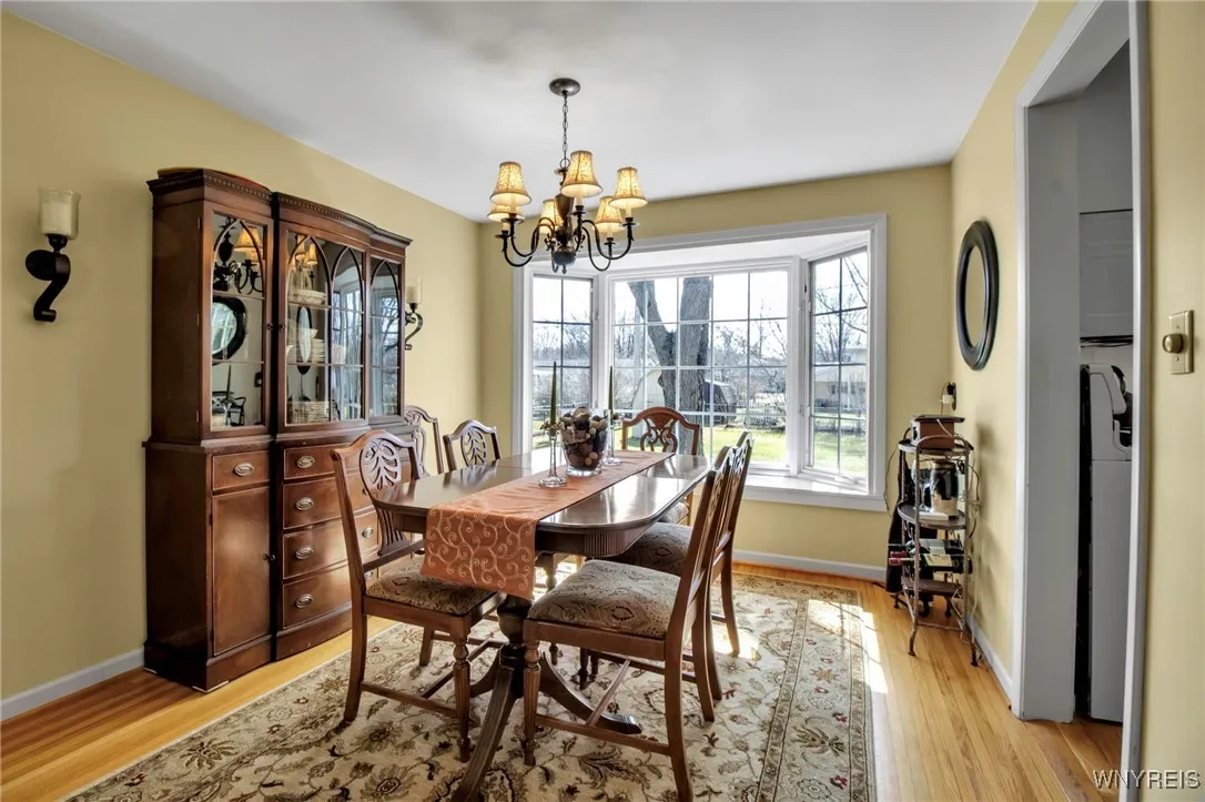 Formal DR w/pretty chandelier, HW flrs + bay windowed views