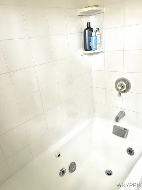 Jetted tub in ceramic tiled bath/shower