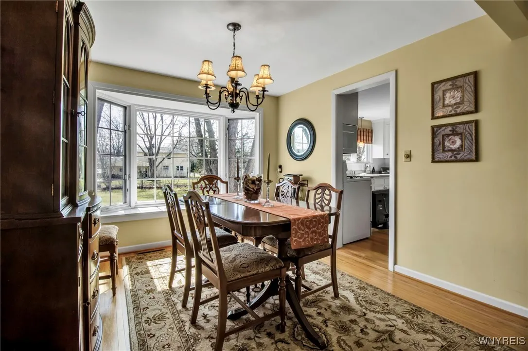 Formal DR w/HW flrs, pretty chandelier + bay window