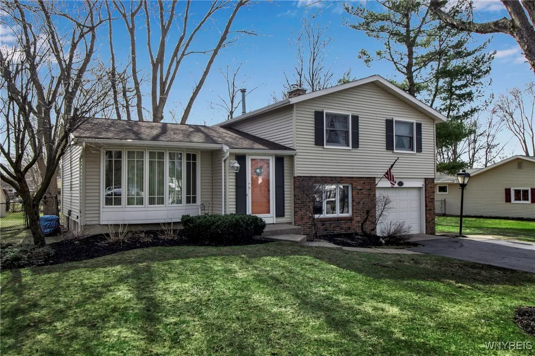 Front view of vinyl + brick low maint. home