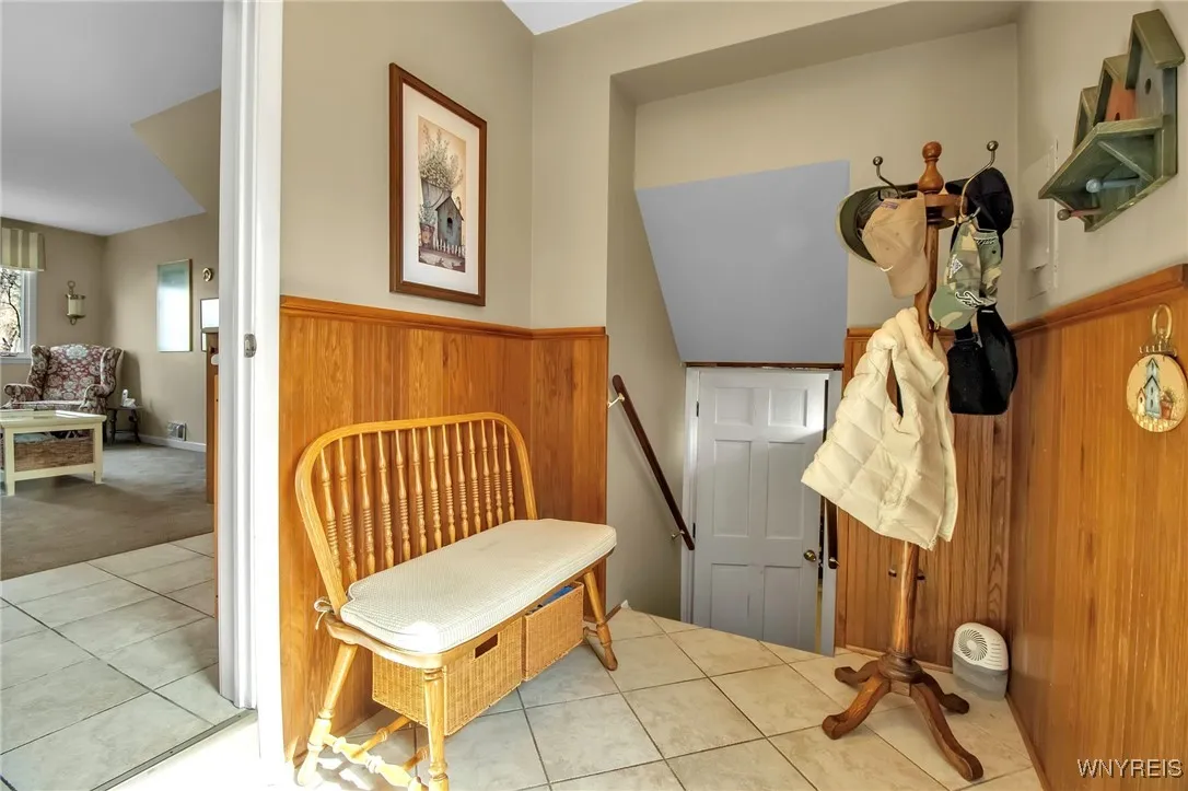 Ceramic tiled back entrance, wainscoated walls+stairs to Rec Rm